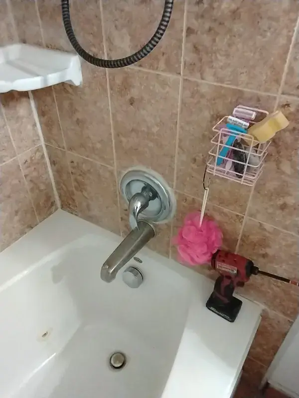 A tub and shower valve being diagnosed for a leak in Pearland