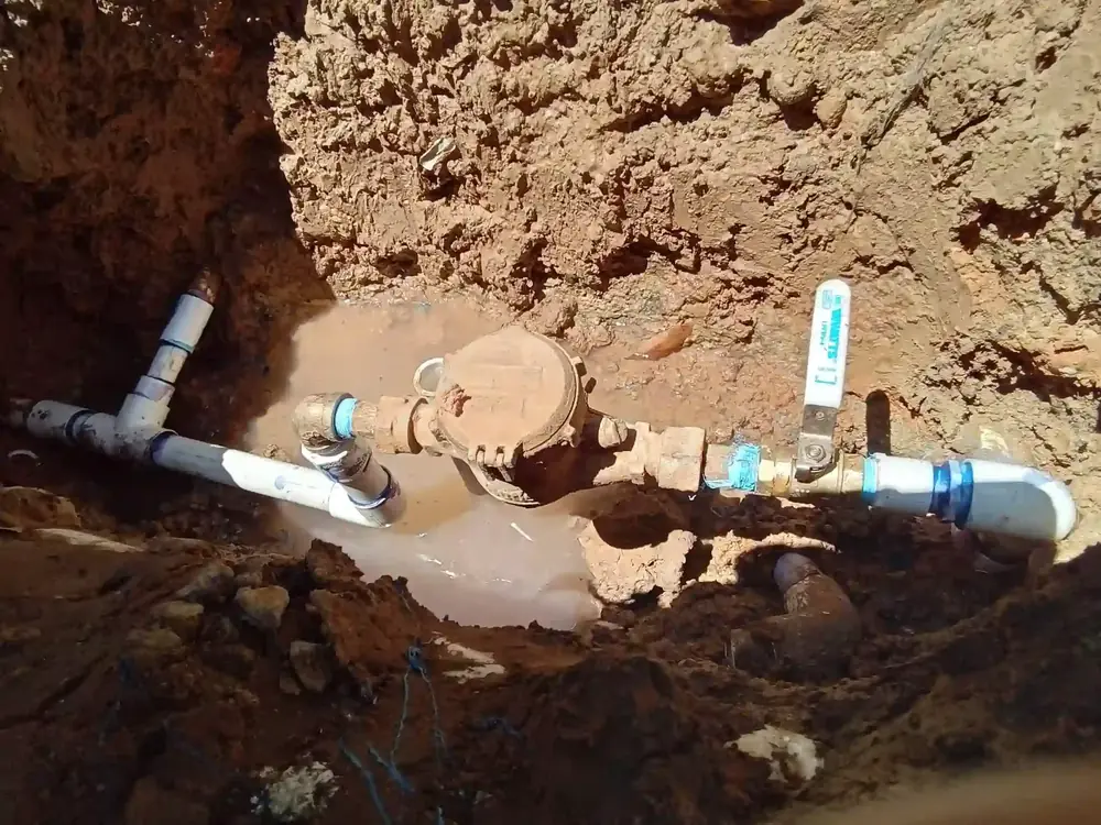 Texas Quality Plumbing technician replacing a water valve at the meter on a Houston property