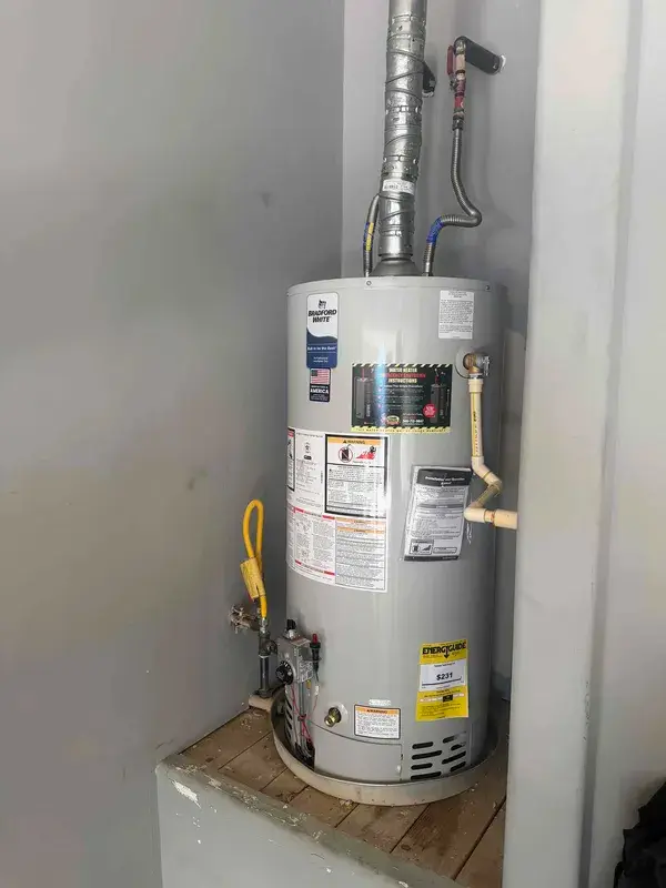 A new gas water heater installed in a Houston garage by Texas Quality Plumbing