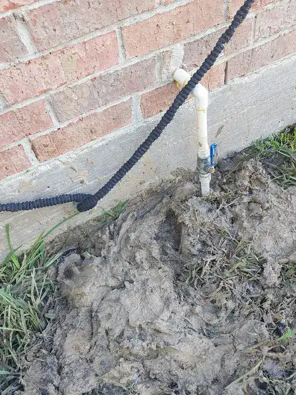 Excavated yard exposing the repaired main water line at a League City home