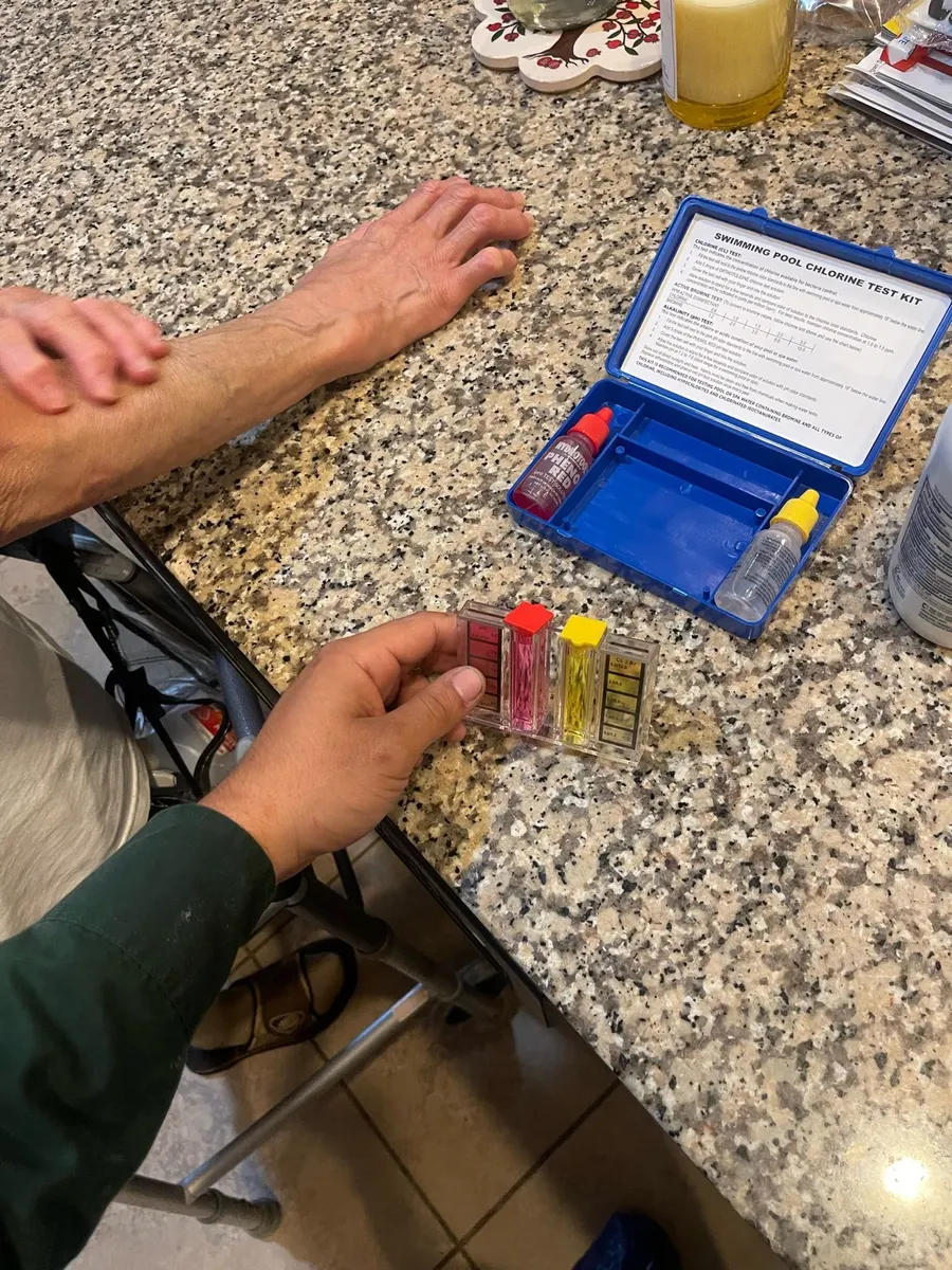 A Texas Quality Plumbing technician performing a water analysis test in a Houston home